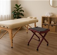 A traveling massage therapist working without proper seating